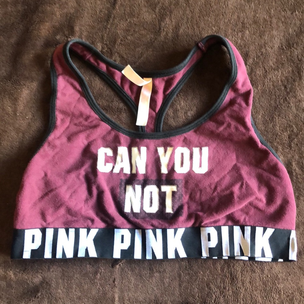 It is a burgundy, black, and white sports bra.